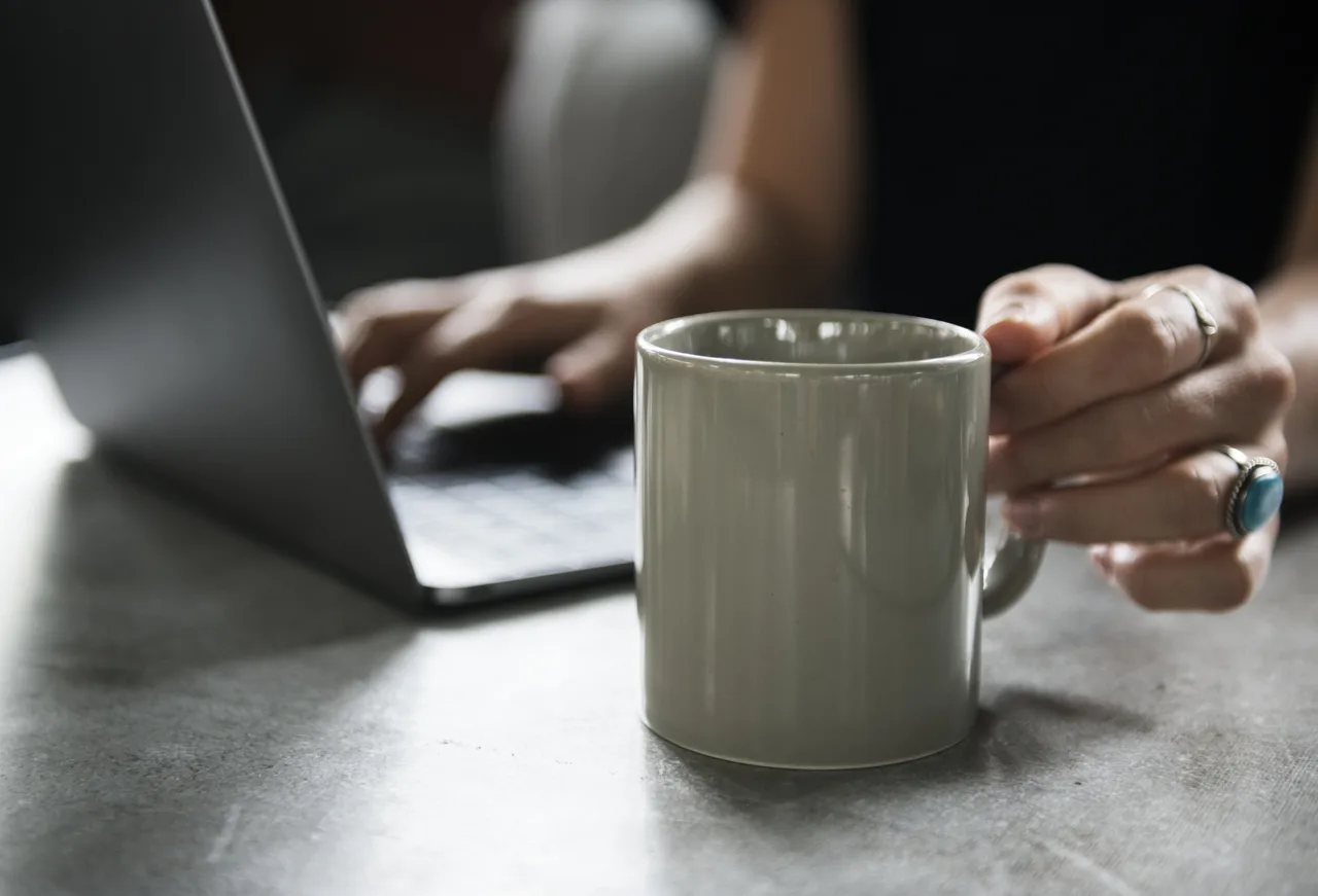 Beverage Mug and a Laptop